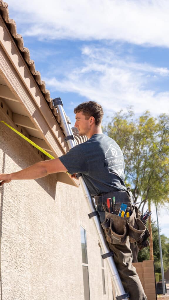 Arizona radon llc technician is installing a radon fan system at a home in arizona.