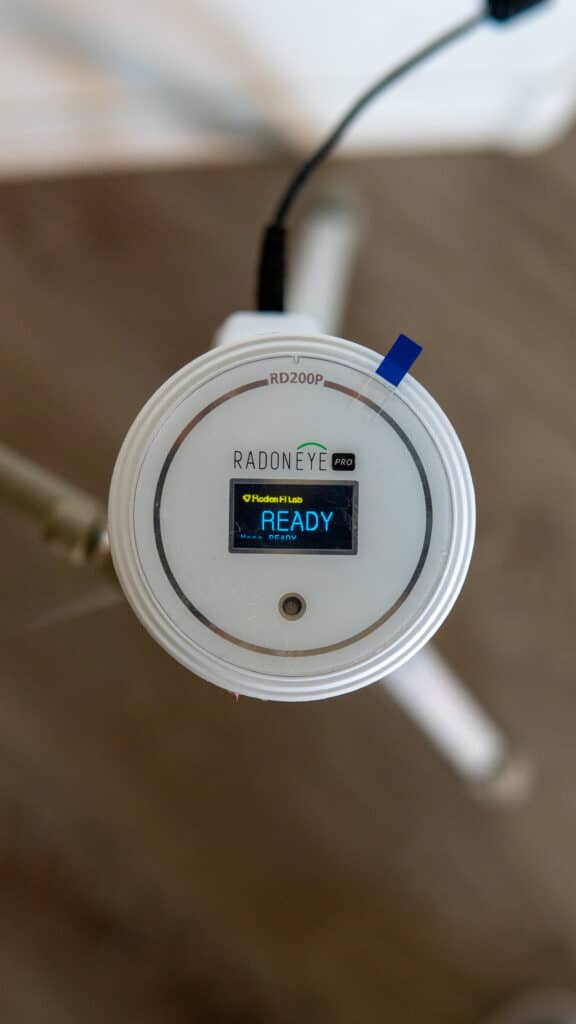 Radon detection equipment being setup in a home.